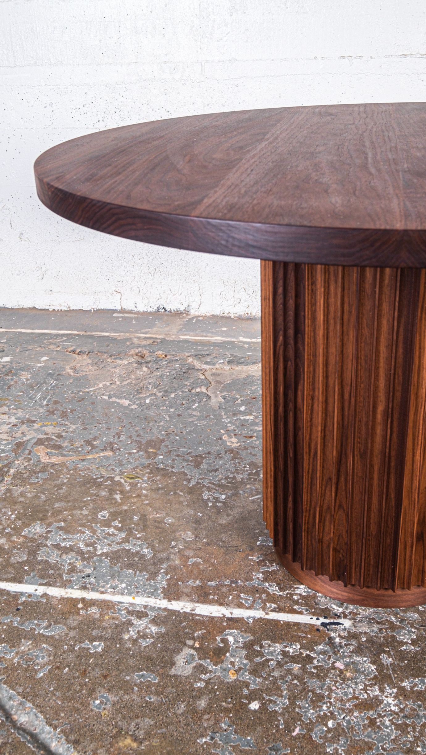 Side closeup of custom built round wooden table